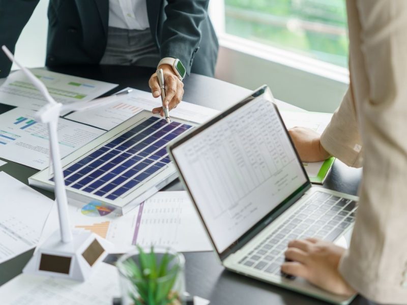 Solar panels green energy Business people working in green eco friendly office business meetingÂ creative ideas for business eco friendly professional teaching corporate people sustainable electricity project business.
